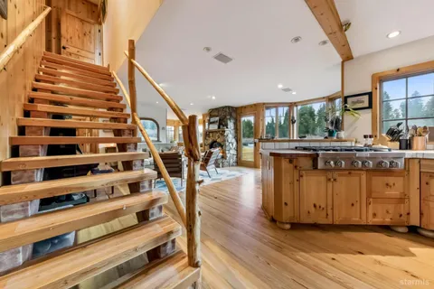 a spacious bedroom with a bed a table and large windows