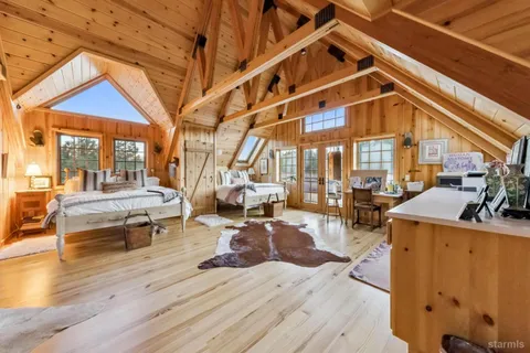 a living room with furniture and large windows