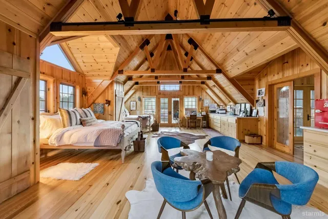 a bedroom with a large bed and a window