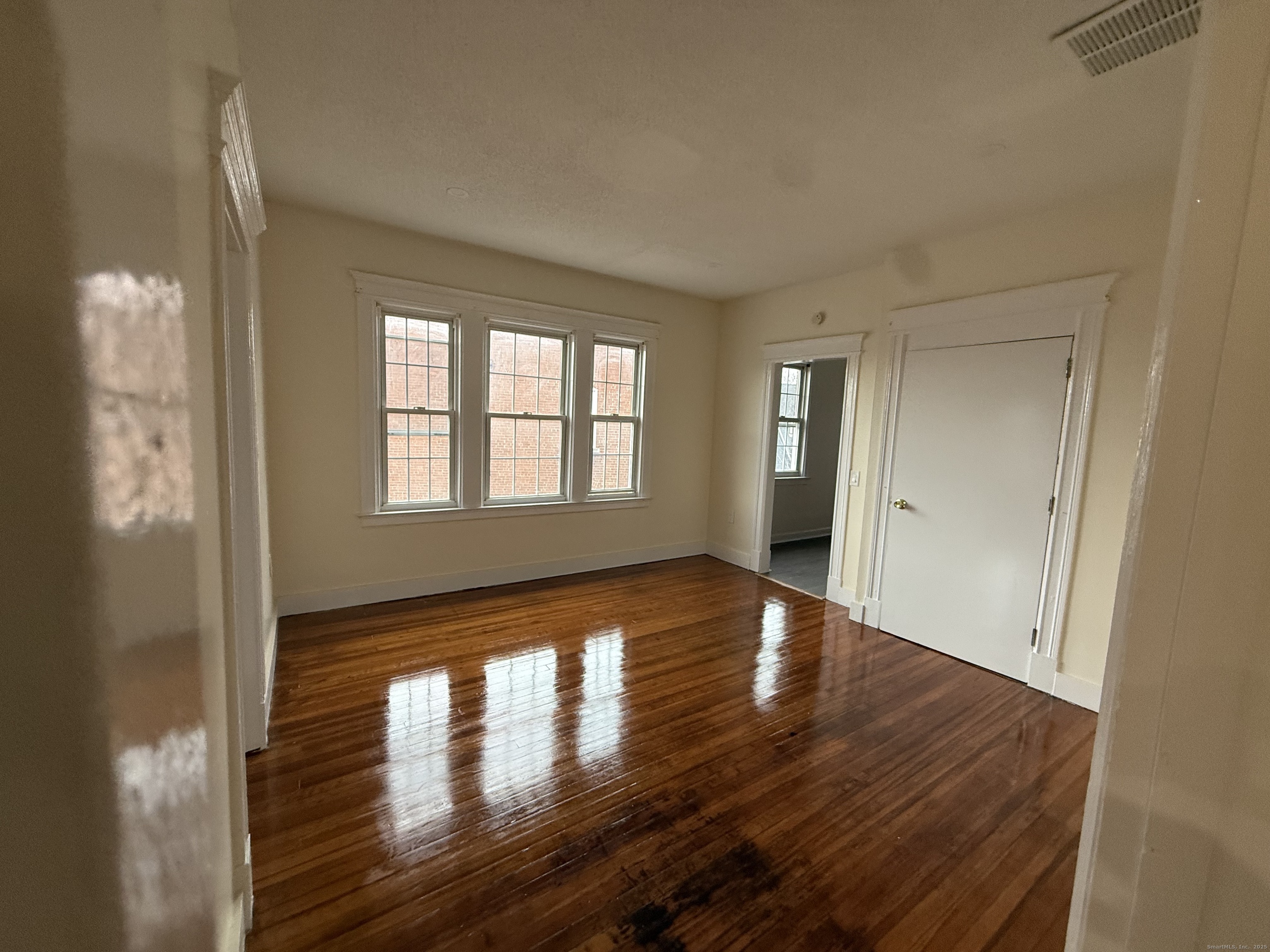 204 Homestead Avenue, Unit 3 Hartford, CT 06112 - Photo 4 of 7 a view of empty room with wooden floor and fan