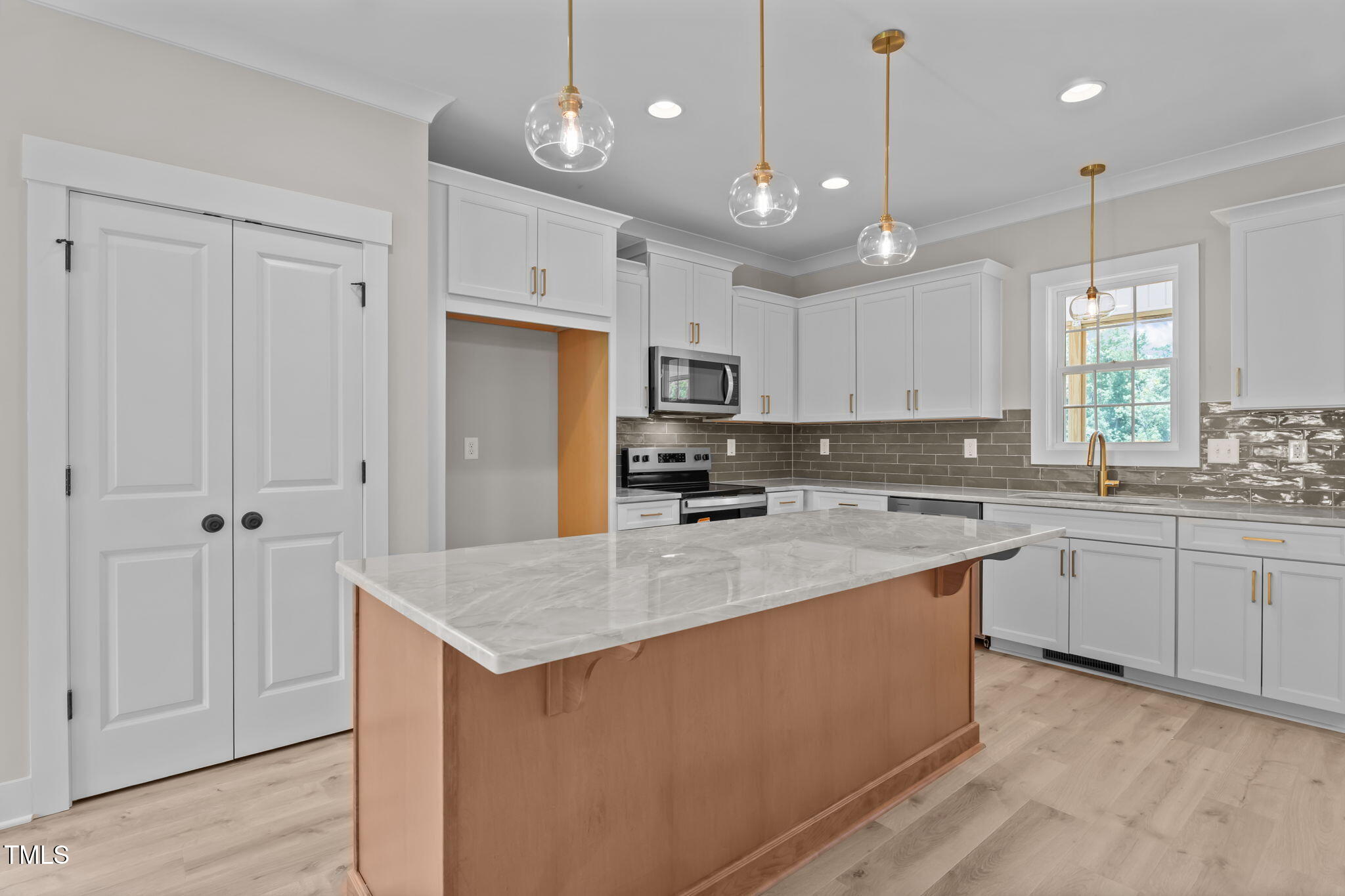 55 Stream Vw Way Spring Hope, NC 27882 - Photo 5 of 37 a kitchen with kitchen island a sink stainless steel appliances and white cabinets