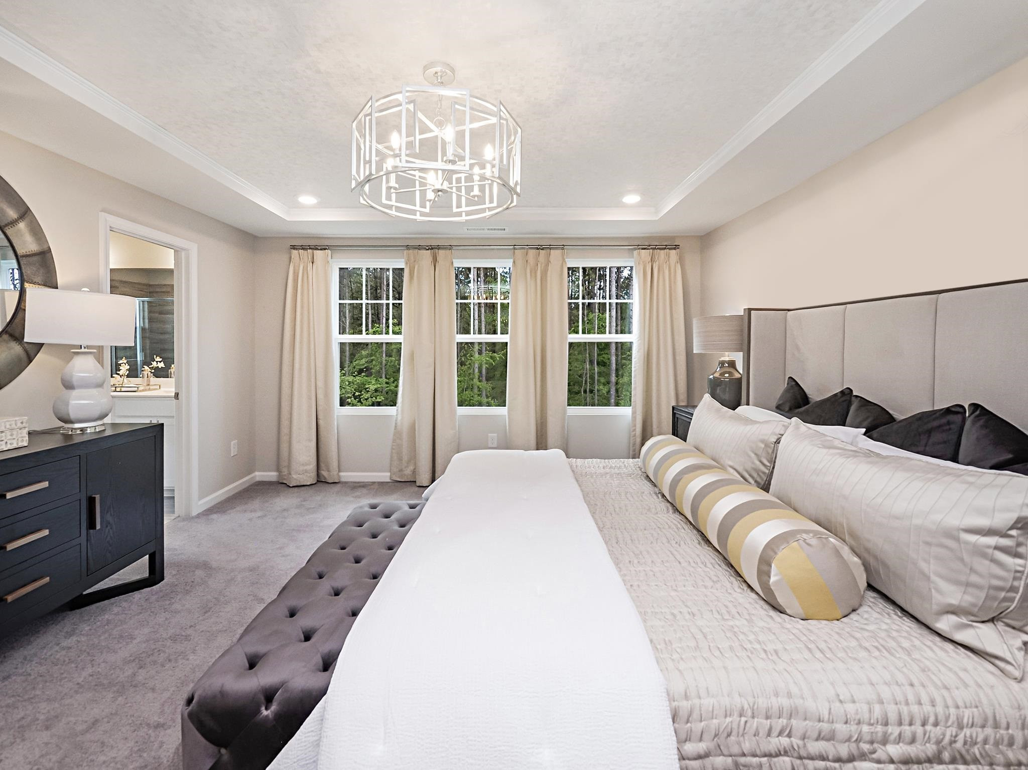 5819 Millstone Way Sims, NC 27880 - Photo 15 of 19 a spacious bedroom with a bed a chandelier and a large window