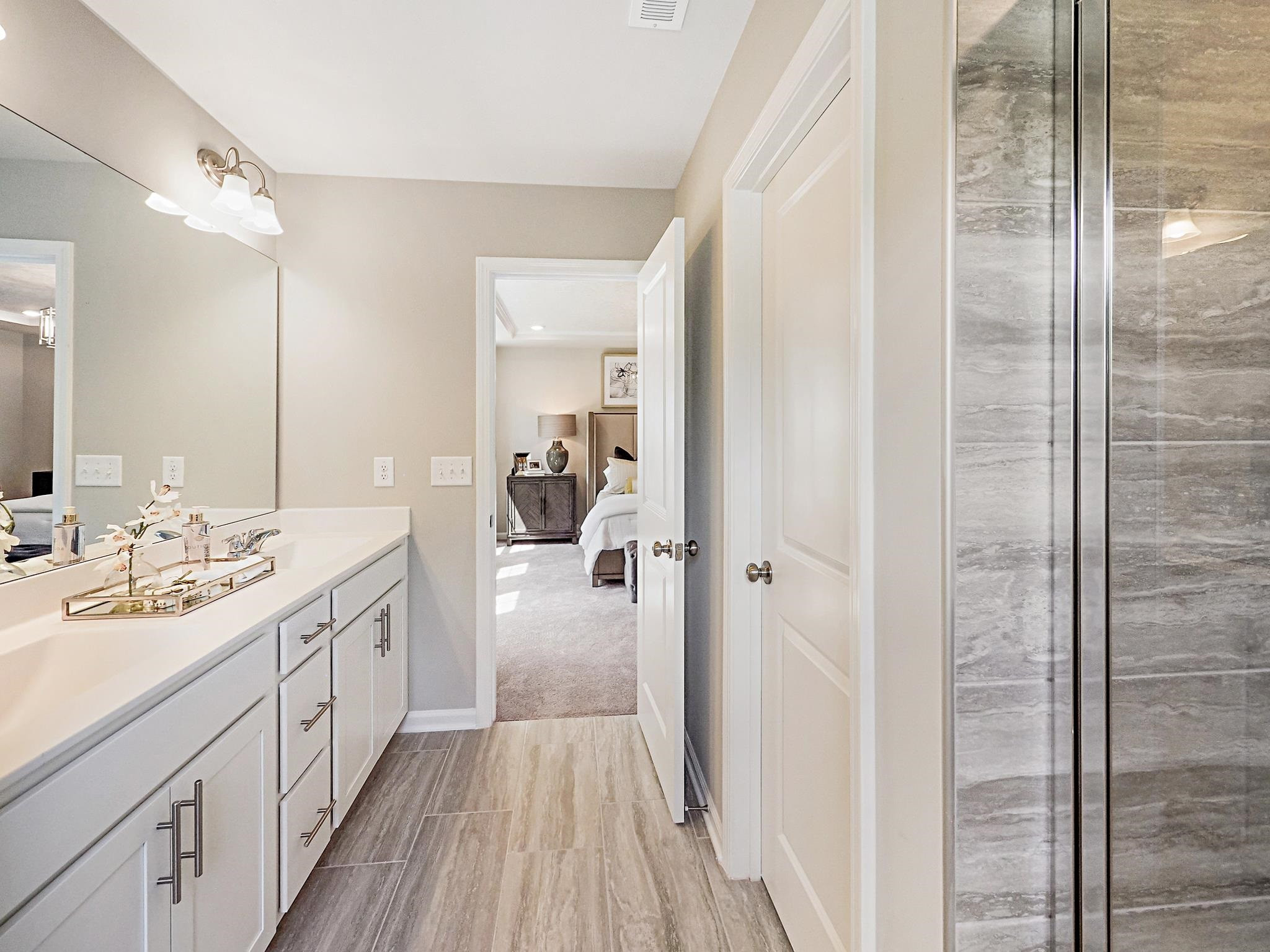 5819 Millstone Way Sims, NC 27880 - Photo 18 of 19 a spacious bathroom with a double vanity sink a mirror and shower