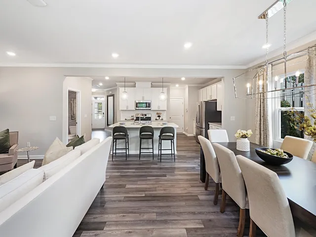a living room with lots of furniture and kitchen view