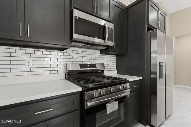 a kitchen with a stove and a microwave