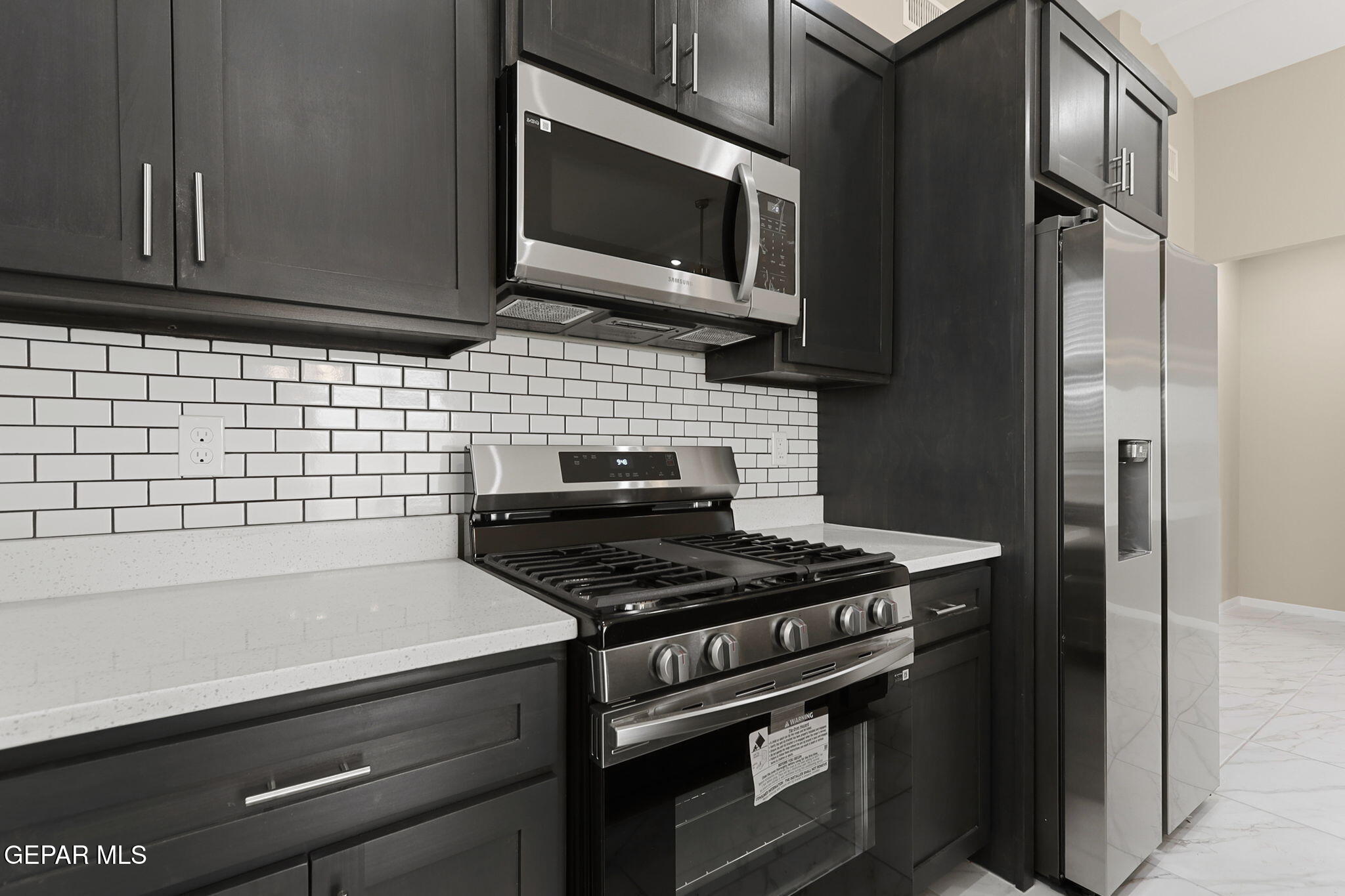 8416 Fish Place Vinton, TX 79821 - Photo 10 of 20 a kitchen with a stove and a microwave