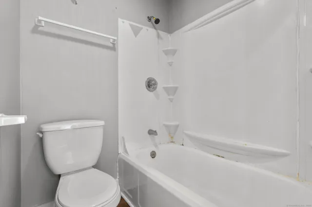 a bathroom with a toilet and shower