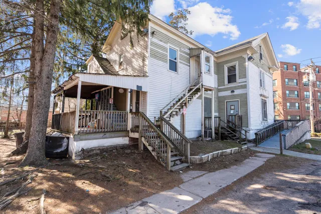 a view of house with a yard