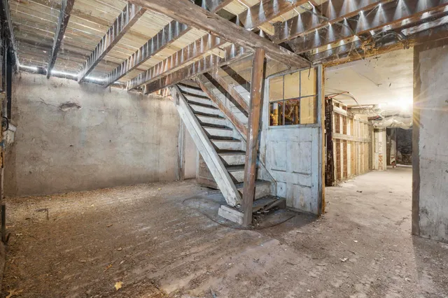 a view of an empty room with stairs