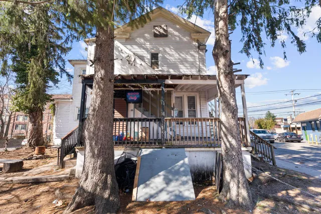 a view of a house with a large tree
