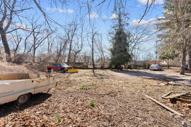 a view of road with large trees