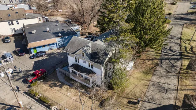 an aerial view of a house with a yard and sitting area