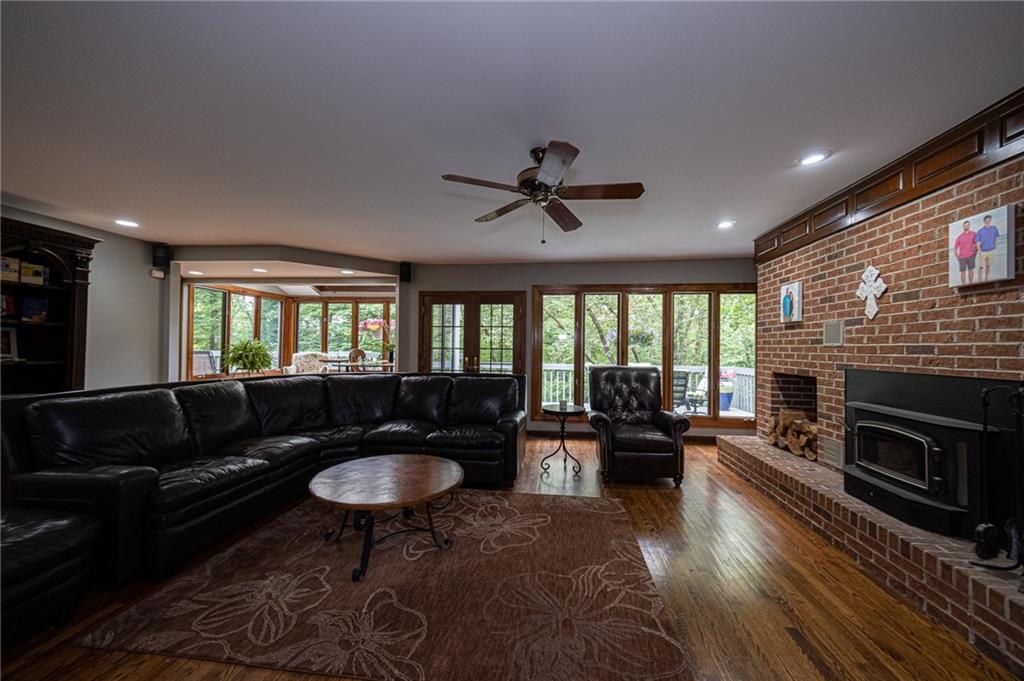 234 Overbrook Road Valencia, PA 16059 - Photo 9 of 25 Large family room with brick fireplace and hardwood flooring.