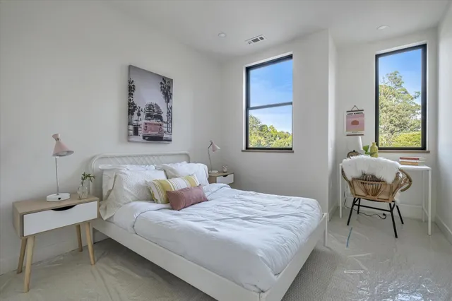 a bedroom with a bed and a window