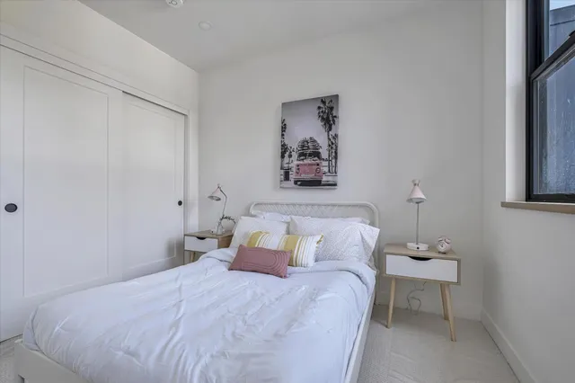 a bedroom with a bed and a wall painting