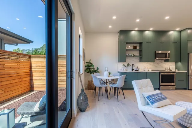 a view of kitchen with kitchen island dining table and chairs