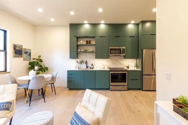 a kitchen with stainless steel appliances kitchen island granite countertop a sink and cabinets