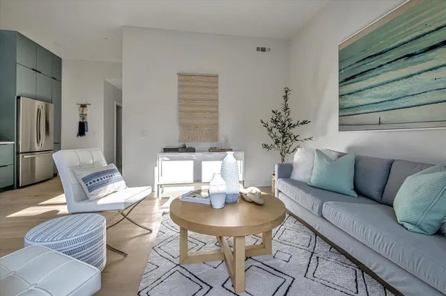 a living room with furniture potted plant and a window