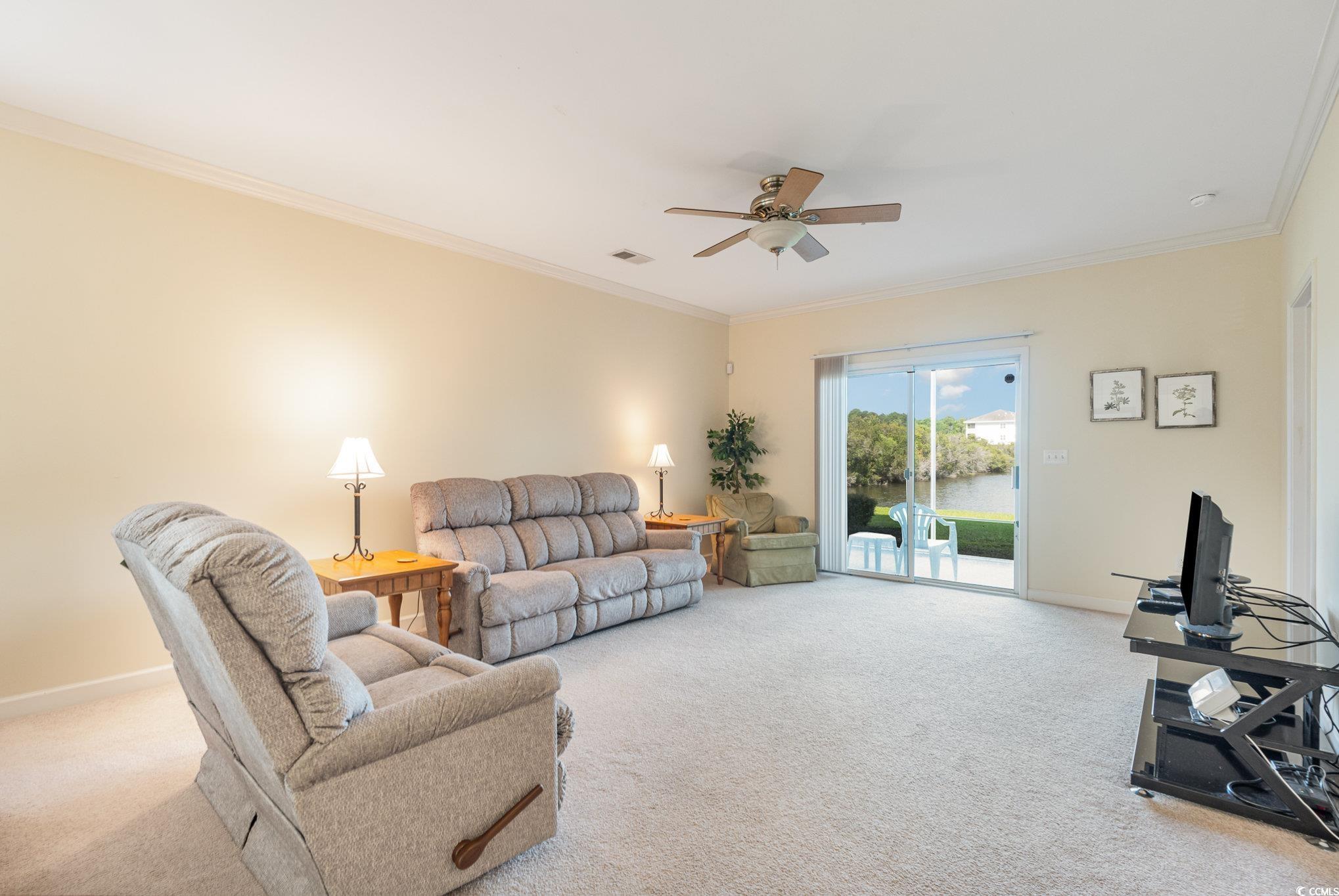 336 Kiskadee Loop, Unit A Conway, SC 29526 - Photo 12 of 27 Carpeted living room with ceiling fan and crown mo