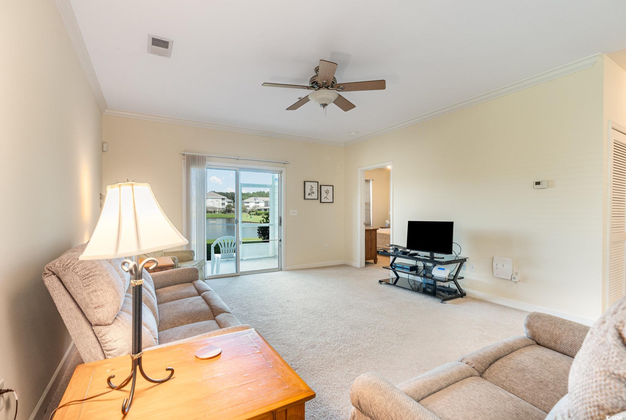 336 Kiskadee Loop, Unit A Conway, SC 29526 - Photo 13 of 27 Carpeted living room with ceiling fan and ornament