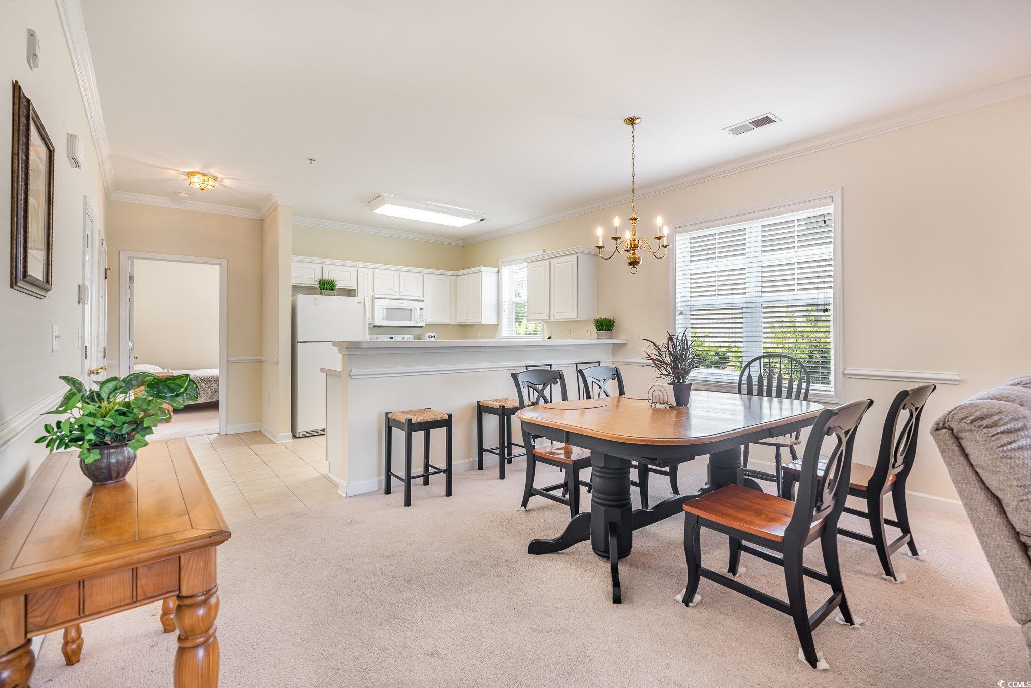 336 Kiskadee Loop, Unit A Conway, SC 29526 - Photo 6 of 27 Carpeted dining space with crown molding and an in