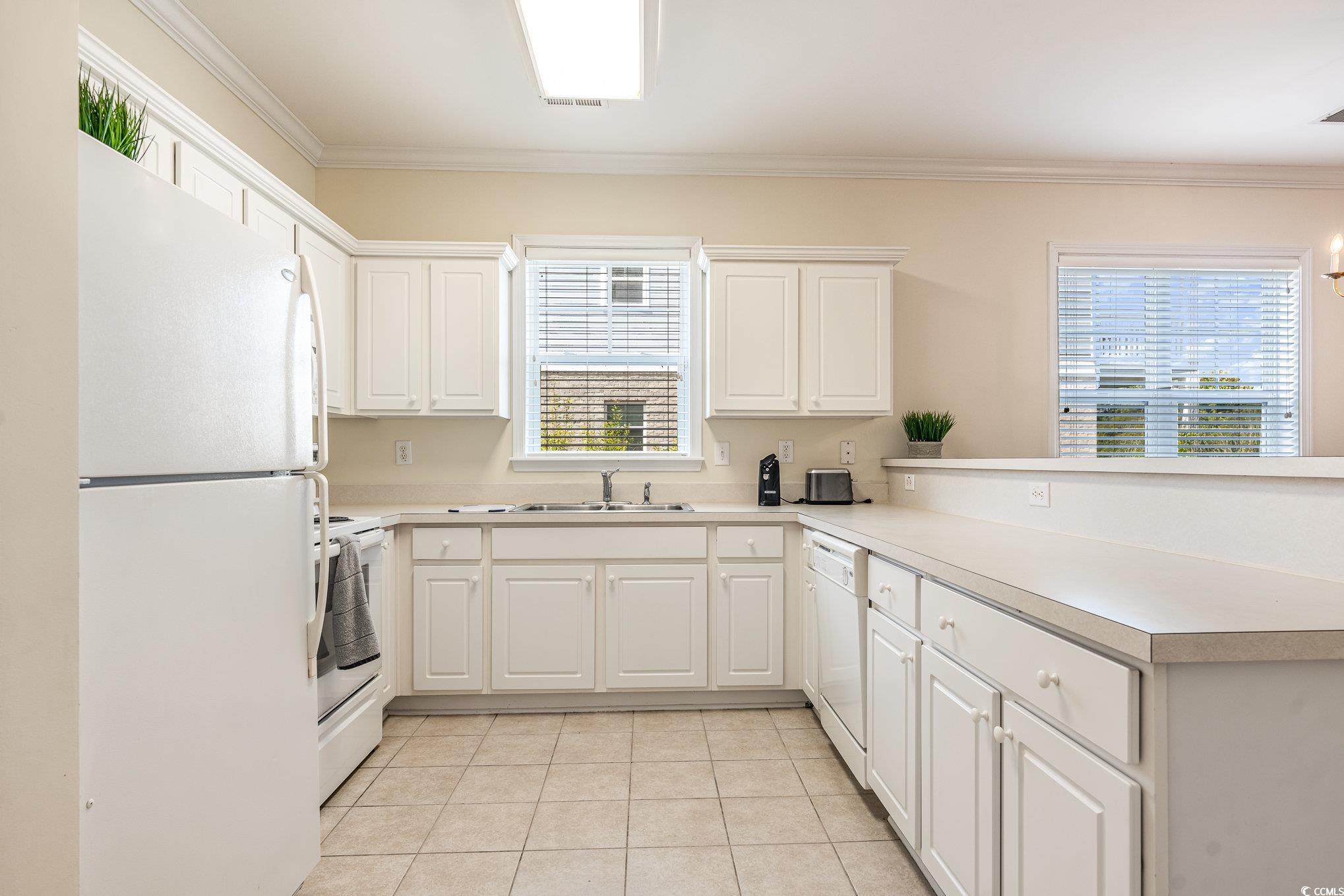 336 Kiskadee Loop, Unit A Conway, SC 29526 - Photo 7 of 27 Kitchen featuring ornamental molding, white cabine
