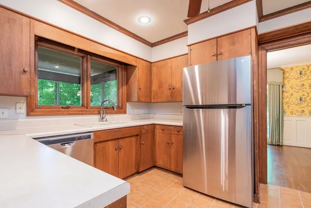 a kitchen with stainless steel appliances granite countertop a refrigerator and a sink