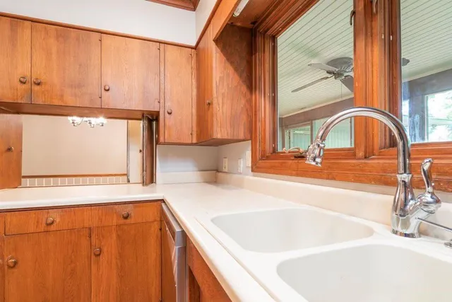 a view of a sink a microwave and a window