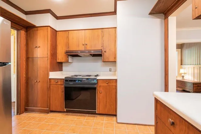 a kitchen with stainless steel appliances granite countertop a stove a sink and a refrigerator