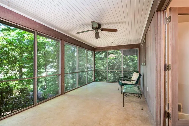 a view of a porch with furniture and a yard
