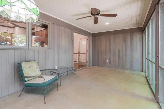 a living room with furniture and a ceiling fan