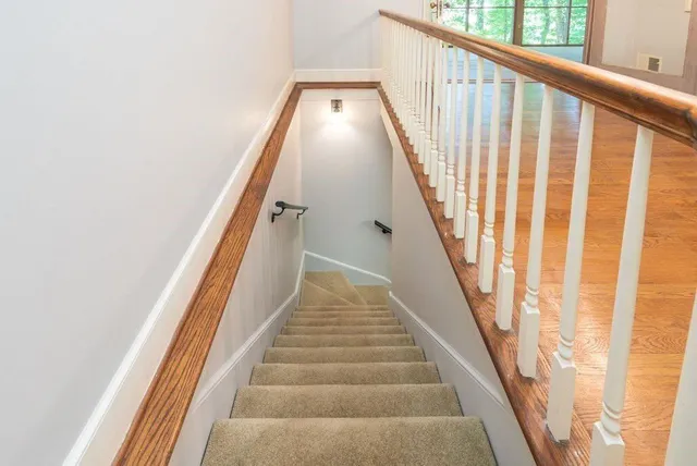 a view of staircase with black white walls
