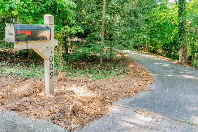 a pathway of a house with a yard