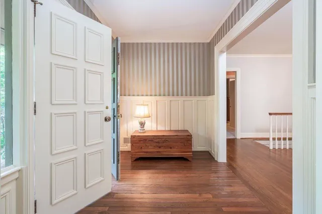 a view of front door with furniture and wooden floor
