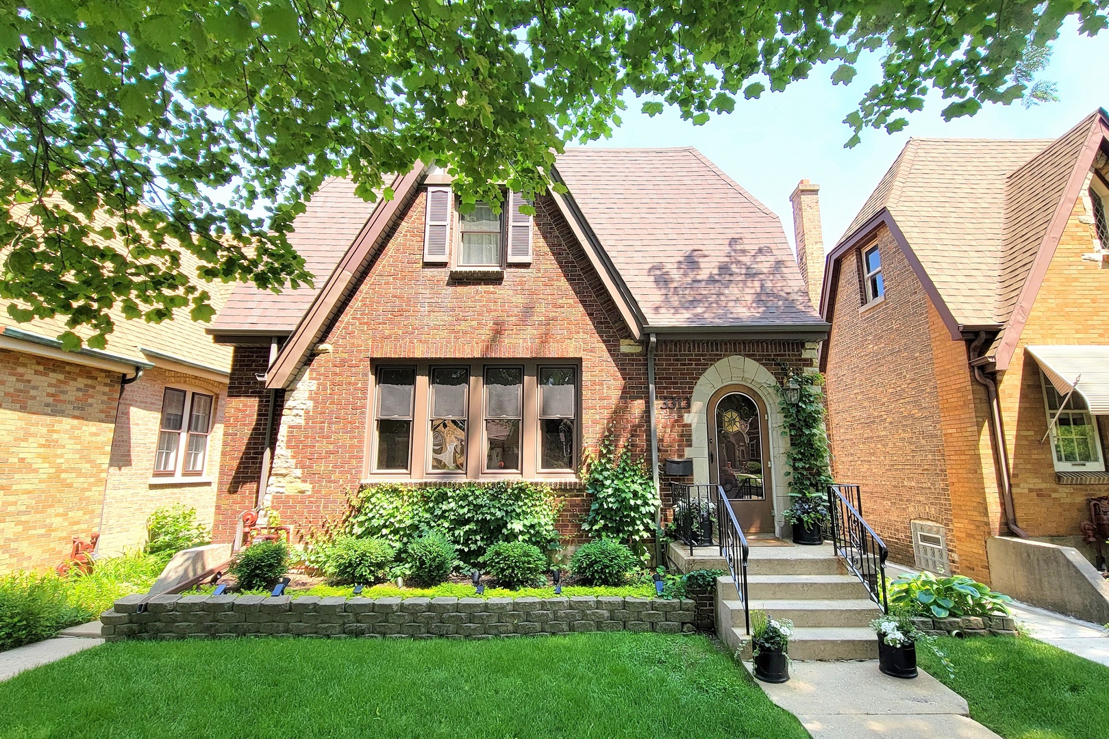 a front view of a house with a garden