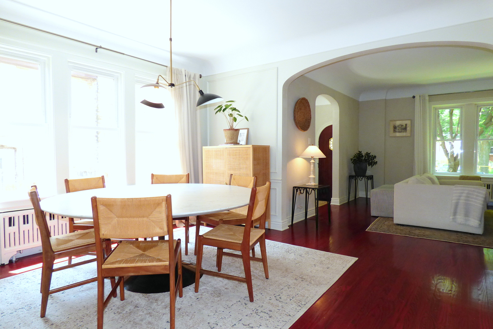 3313 North Rutherford Avenue Chicago, IL 60634 - Photo 5 of 38 a dining room with wooden floor a chandelier a wooden table and chairs