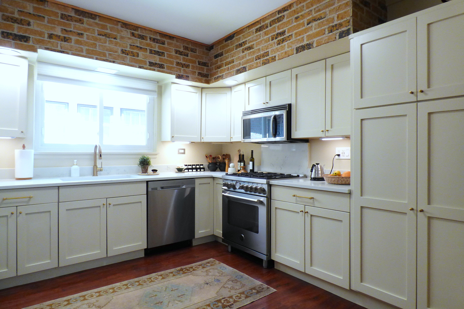 3313 North Rutherford Avenue Chicago, IL 60634 - Photo 6 of 38 a kitchen with white cabinets sink and stainless steel appliances