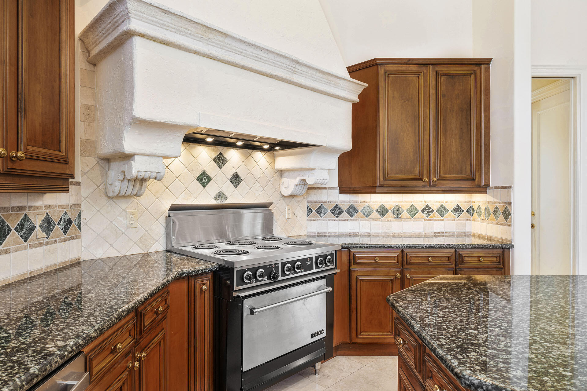 159 Coconut Palm Road Boca Raton, FL 33432 - Photo 21 of 60 a kitchen with granite countertop a sink stove and cabinets