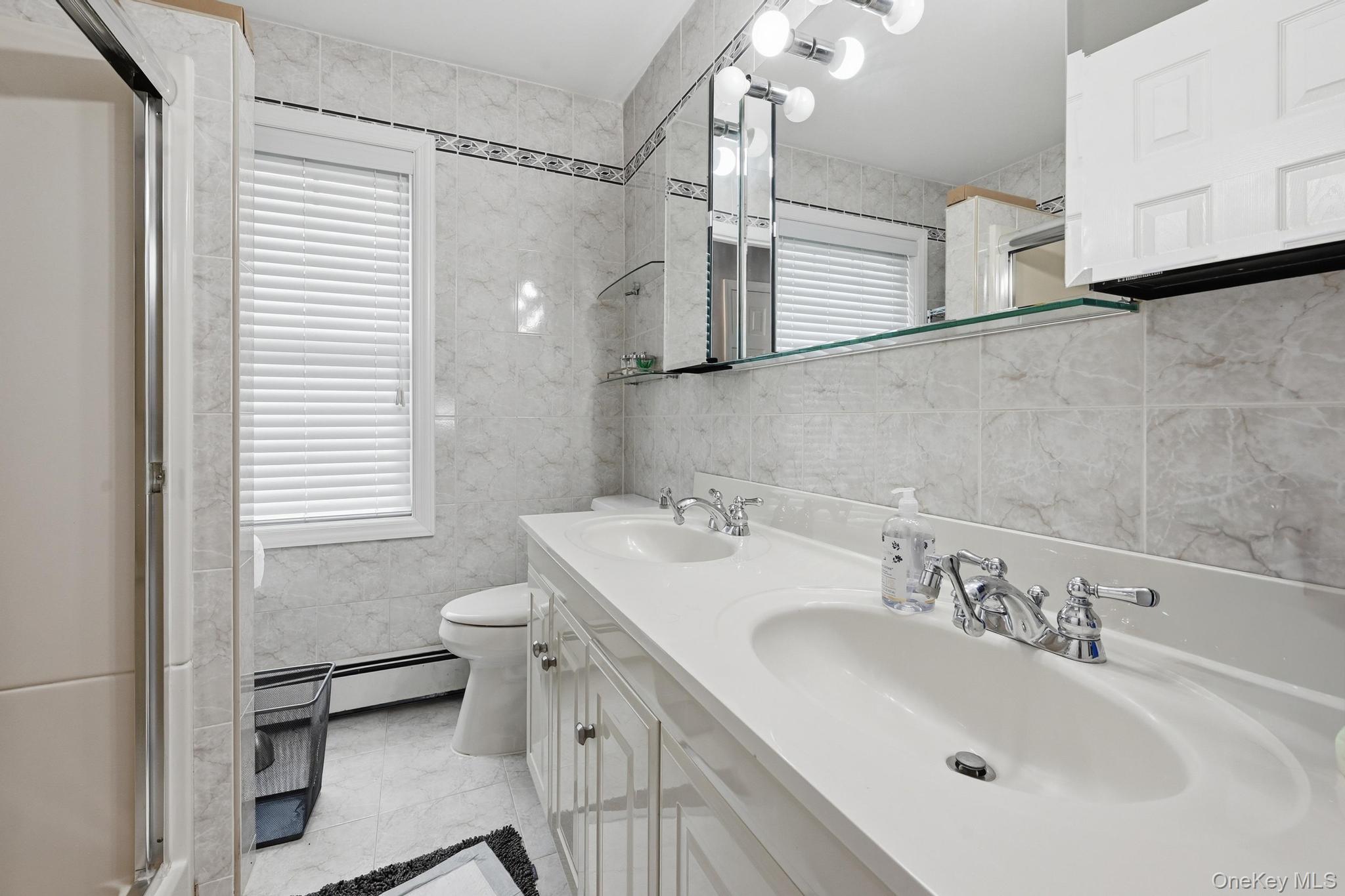 19 Sunset Road West Albertson, NY 11507 - Photo 18 of 24 Dual vanity with integrated sinks and chrome fixtures on the second floor