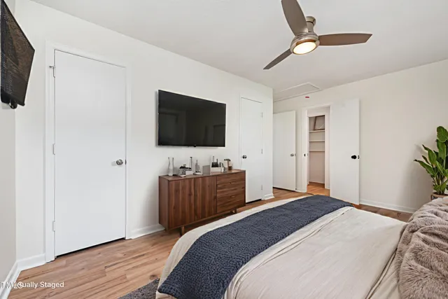 a bedroom with a bed and a flat screen tv