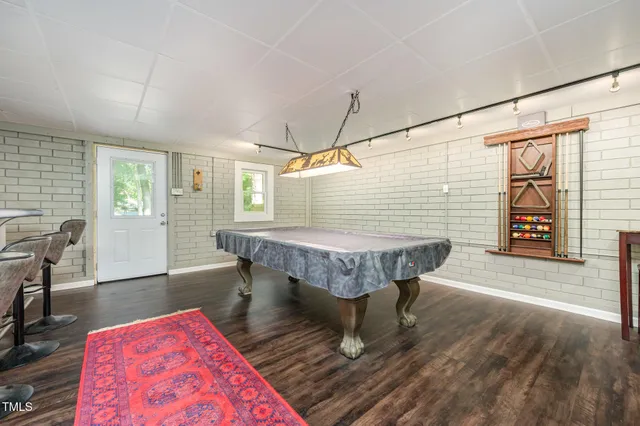 a dining room with furniture and wooden floor