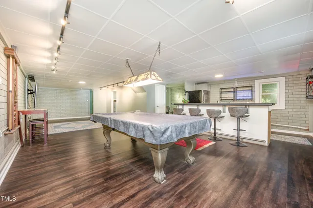 a living room with lots of furniture and wooden floors