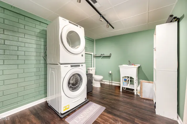 a utility room with sink dryer and washer