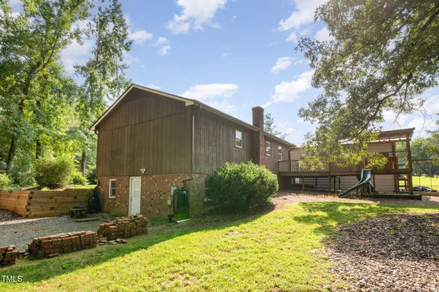 a backyard of a house with table and chairs