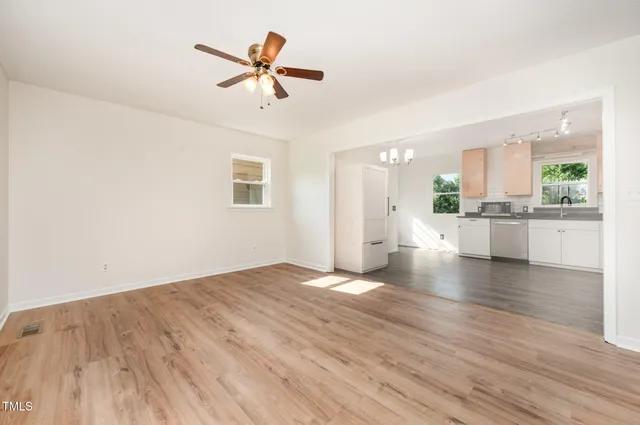 a view of a kitchen with a dishwasher cabinets and wooden floor