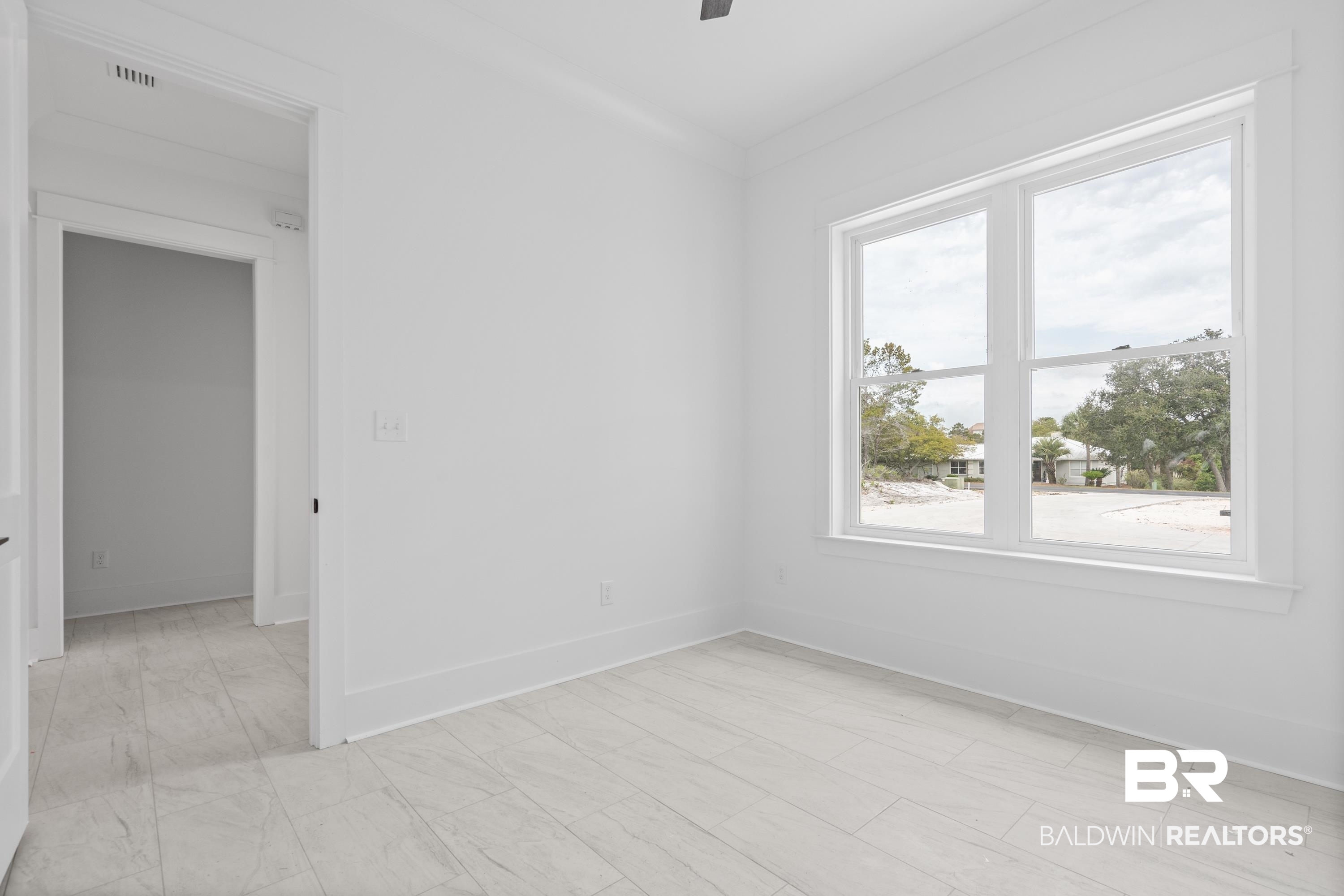 30650 Ono N Loop West Orange Beach, AL 36561 - Photo 28 of 38 Spare room with baseboards, light marble finish floors, and ceiling fan