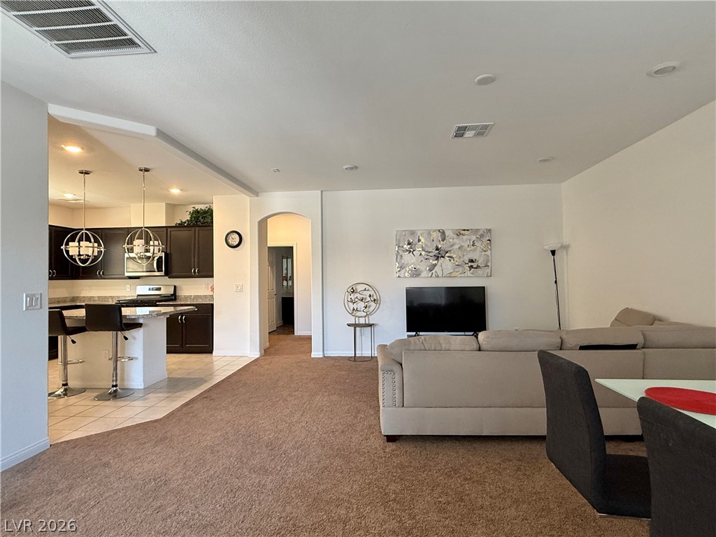 7777 South Westwind Road Las Vegas, NV 89139 - Photo 40 of 46 An inviting open-concept layout connects the well-appointed kitchen to the living area.