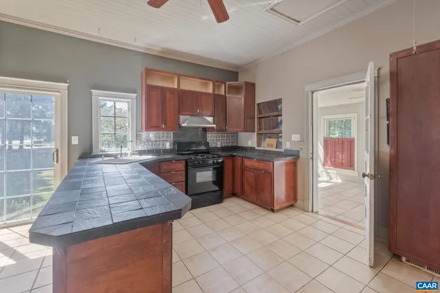 a kitchen with stainless steel appliances granite countertop a stove a sink and a refrigerator