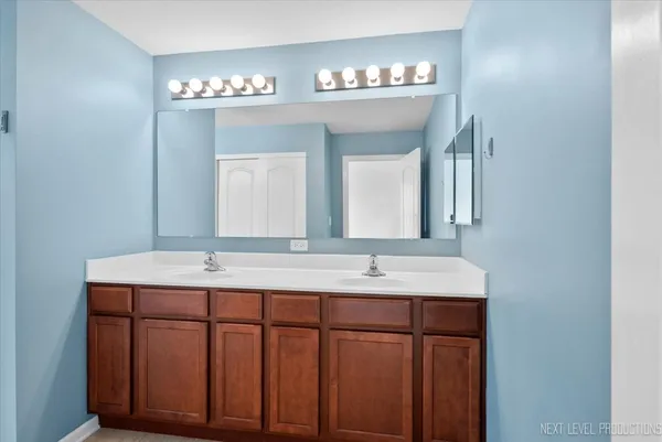 a bathroom with a double vanity sink and a mirror