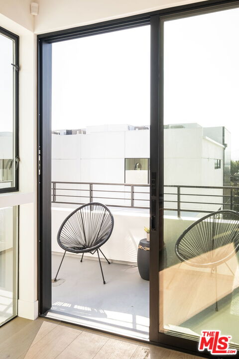 762 North Arthur Road Los Angeles, CA 90029 - Photo 11 of 30 a living room with a floor to ceiling window and a ceiling fan